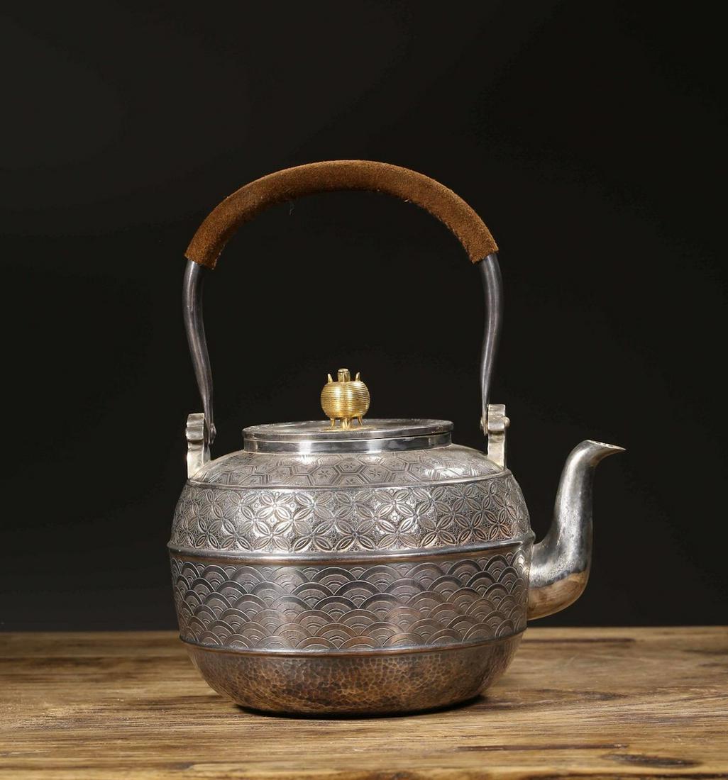 JAPANESE SILVER TEAPOT: Length: 7.1 inches. Width: 5.7 inches. Height: 8.7 inches. Length: 18cm Width: 14.5cm Height: 22cm Weight: 629g Provenance: From the collections of Mr. Matsuda from New Jersey.