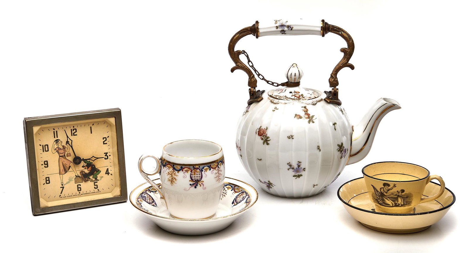 Austrian teapot with two teacups and saucers, and a: Austrianteapotporcelainobscured markwith two teacups and saucers, and a vintage clocktaller: 7"h x 7"dia