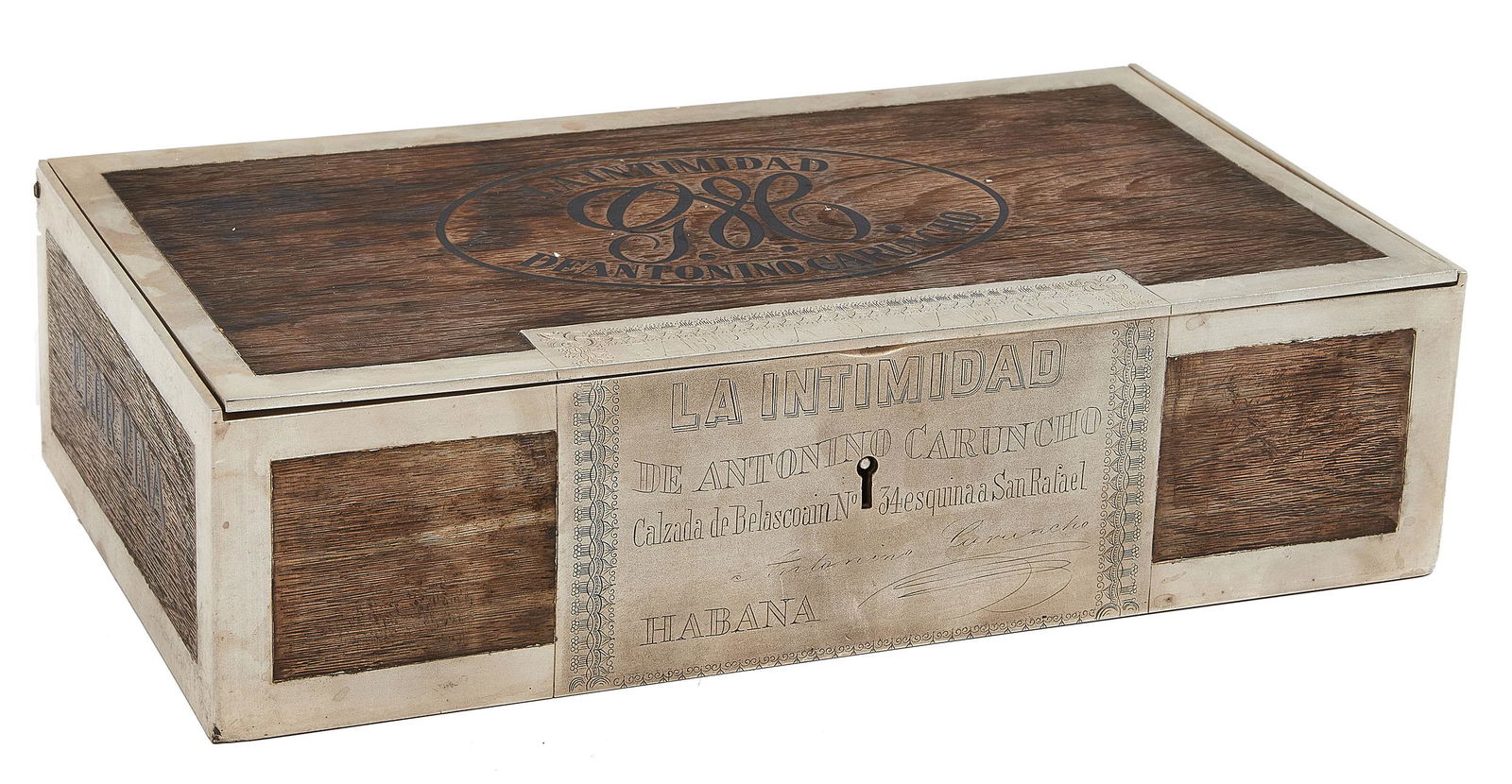 La Intimidad de Antonino Caruncho cigar box: La Intimidad de Antonino Carunchopresentation cigar boxHavana, Cubabronze and silver incised marks 2.5"h x 10"w x 5.5"d </