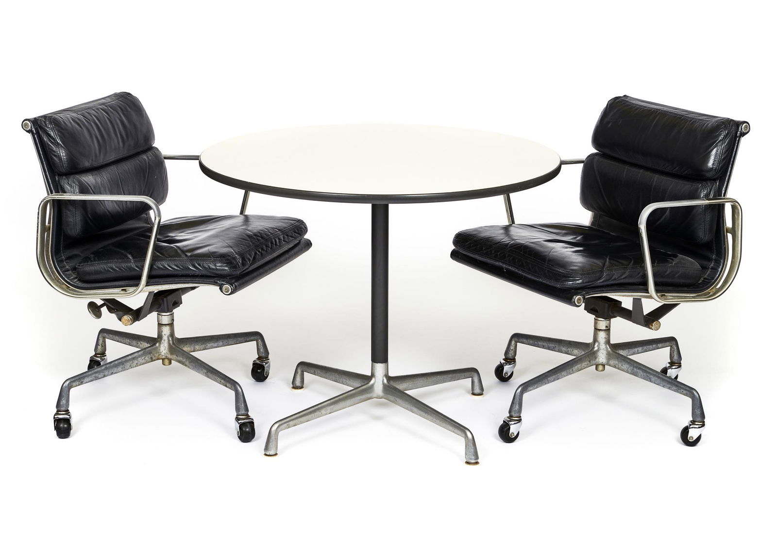 Charles and Ray Eames table and two chairs: Charles and Ray Eames for Herman Millertable and two chairsZeeland, MIleather, metalmarked, dated 1979chairs: 31.5"h x 22.7"wtable: 28.5"h x 35.5"w