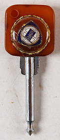 Lancia Keys from a prototype sample folder from the 1930s a: Amber handle with mounted Lancia symbol, unique piece