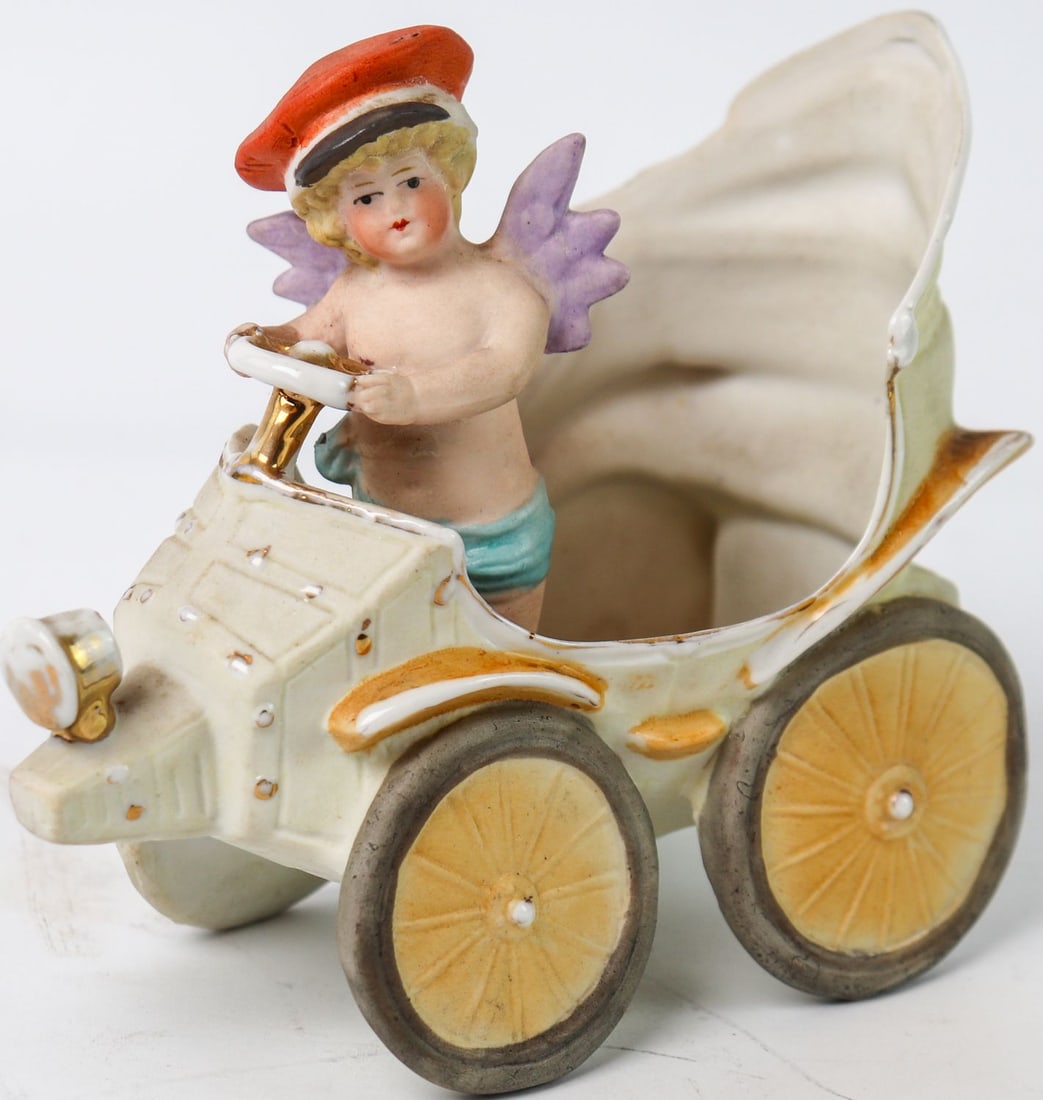 Automobilia Egg cup bisque porcelain model automobile with: Germany c. 1902, France c. 1905, painted and marked, l: 12 cm