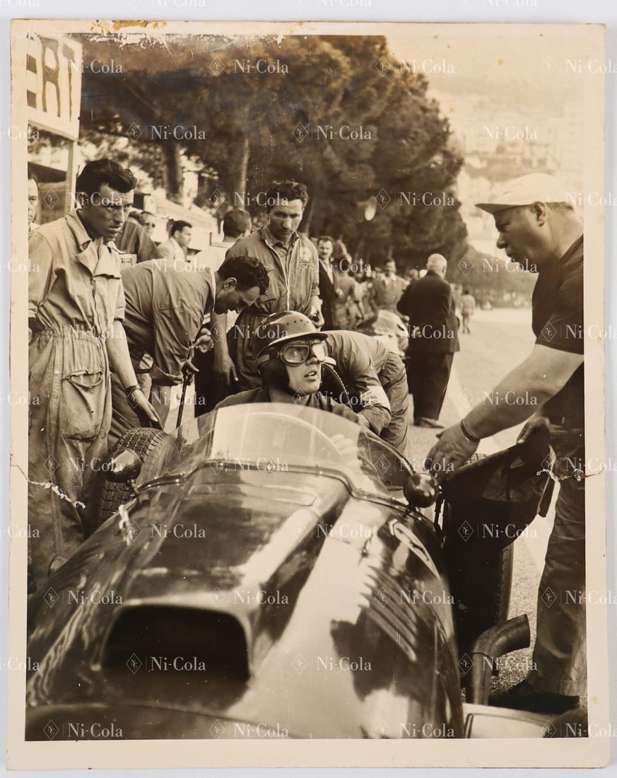 Ferrari Original B/W press photo Grand Prix Monaco 1957: Mike Hawthorn in the cockpit of his Ferrari 801 in the pit lane, photo shows typical racing scene of the 1950s with mechanics and spectators in the background, 25.5 x 20.5 cm, mounted on cardboard