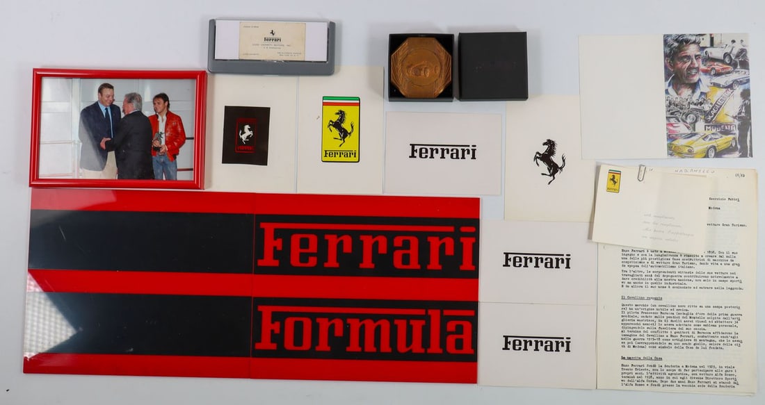 Ferrari 13-piece: Plaque A.m.a.c. dedicated to Ferrari mechanic Carlo Amedessi, business card Luigi Chinetti, Christmas / New Year's card signed by Sergio Scaglietti, advertising stencils from the 1980s etc.