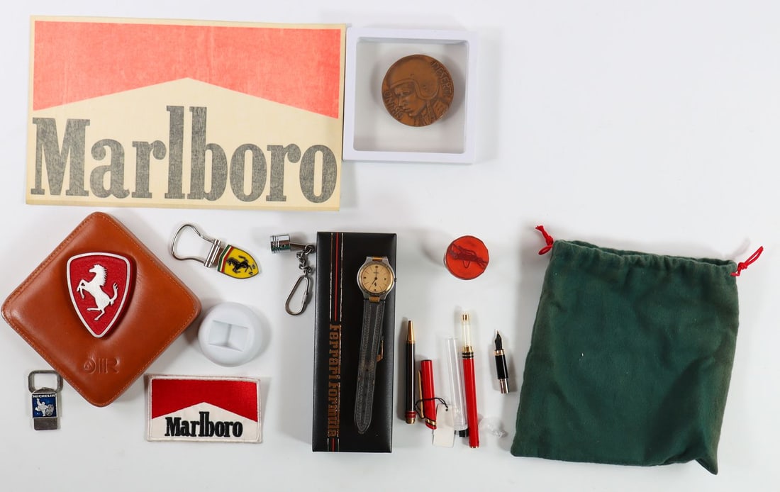 Ferrari 9-piece: Table accessory 'Scudetto Rosso' (leather covered), 12 x 12 x 3 cm, key ring, stamp, Ferrari Formula watch (No. 36417) with original case, Marlboro patch (5.7 x 9.5 cm) and sticker (16 x 26.5 cm),