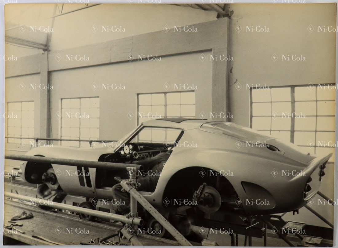 Ferrari Original Large-Format B/W Press Photo Ferrari Facto: The photo shows a Ferrari 250 GTO during assembly in the factory halls in Modena in 1962. 17.5 x 23.7 cm.