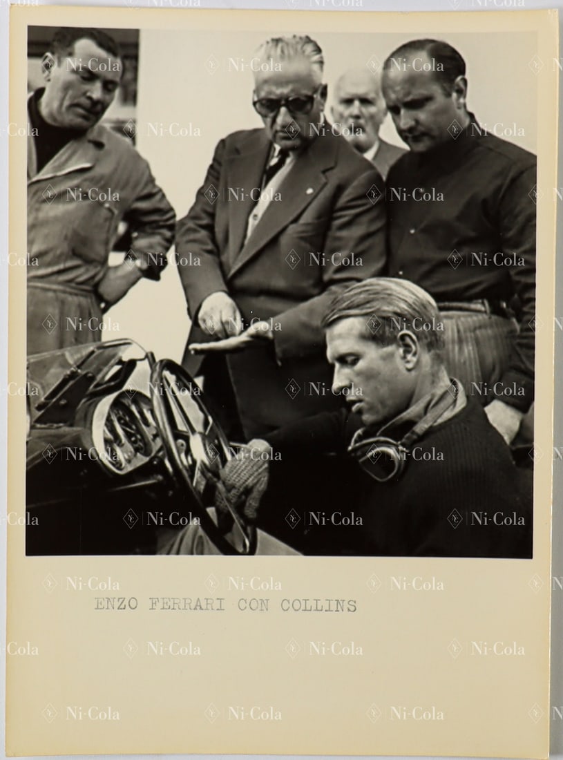Ferrari Original B/W Press Photo of Enzo Ferrari together w: In the center, Enzo Ferrari with his characteristic sunglasses. In the cockpit sits Peter Collins. On the far right, wearing a dark shirt, is the then factory test driver Martino Severi. 17.5 x 12.5