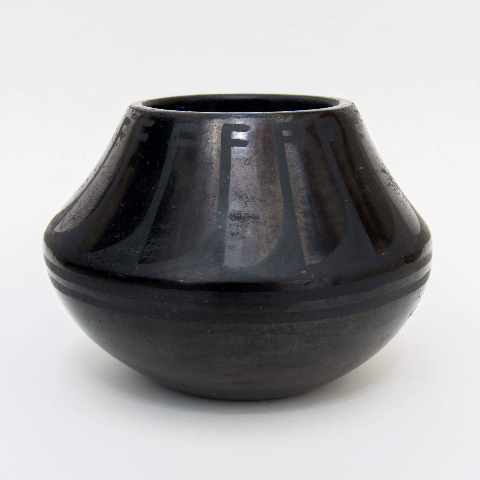 Vintage San Ildefonso Feather Blackware Pottery Jar: Vintage San Ildefonso Feather Blackware Pottery JarGood condition with no cracks. A couple minor body bumpsMeasures 5” H x 3 1/2” W.Hand formed jar. Nicely detailed feather pattern on this earlier