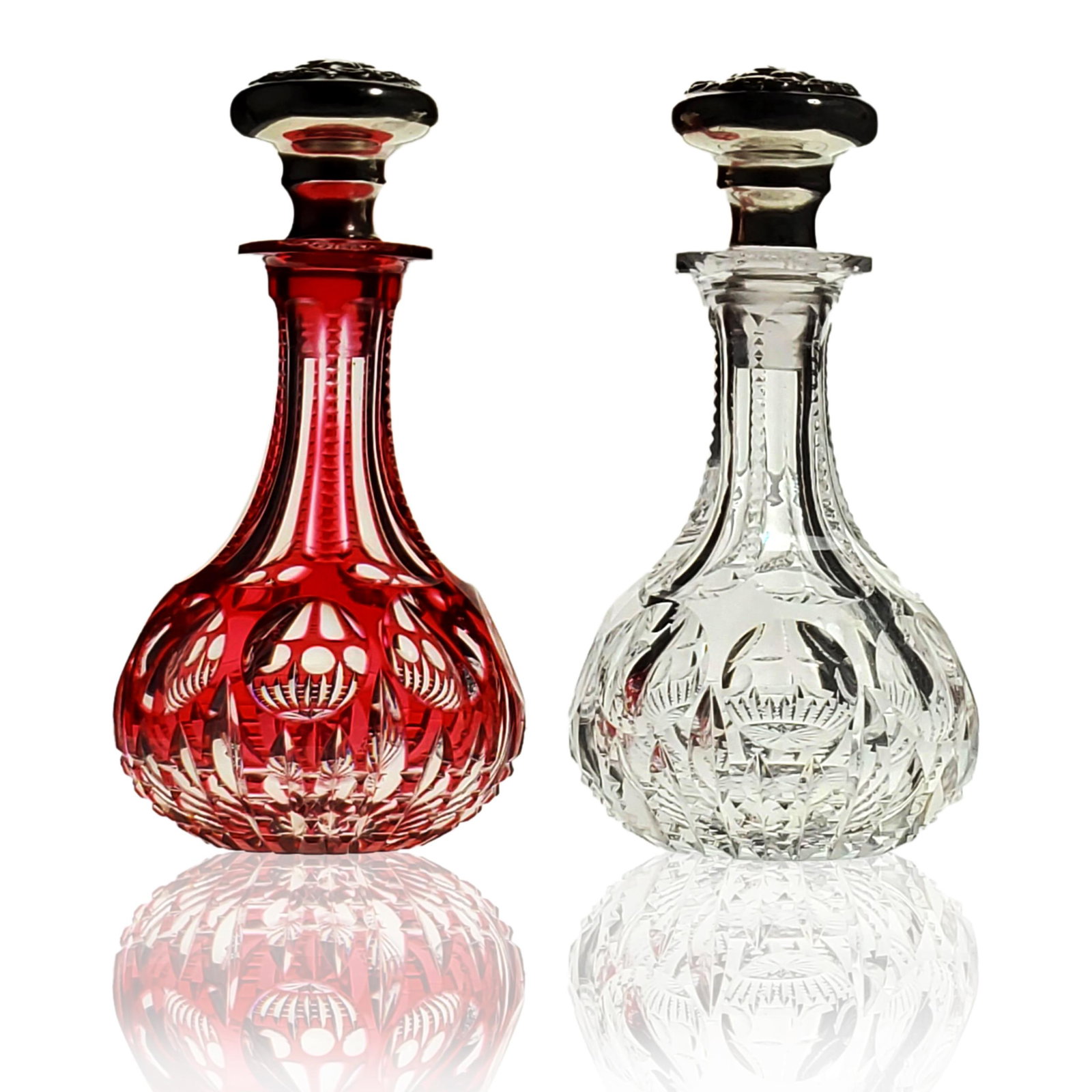 Petite Pr of ABP cut glass perfume bottles "CAMBRIDGE": Petite Pr of ABP cut glass perfume bottles, one cranberry cut to clear and one clear. Both cut in Pairpoint "CAMBRIDGE" pattern with matching sterling silver tops. Measures 4" tall each