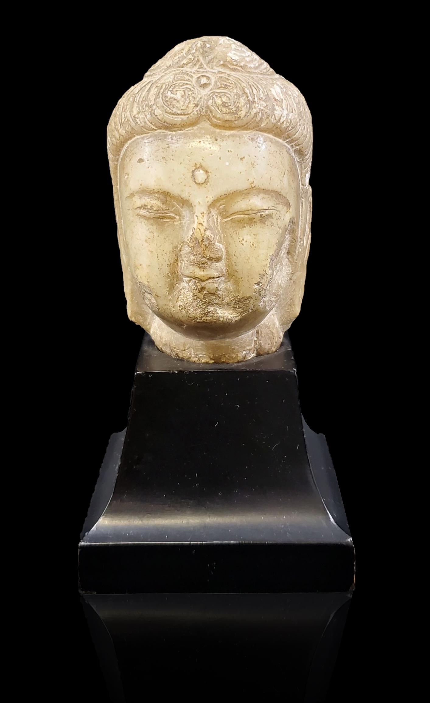 Antique carved stone Buddha head, possibly dating to S (1 of 20)