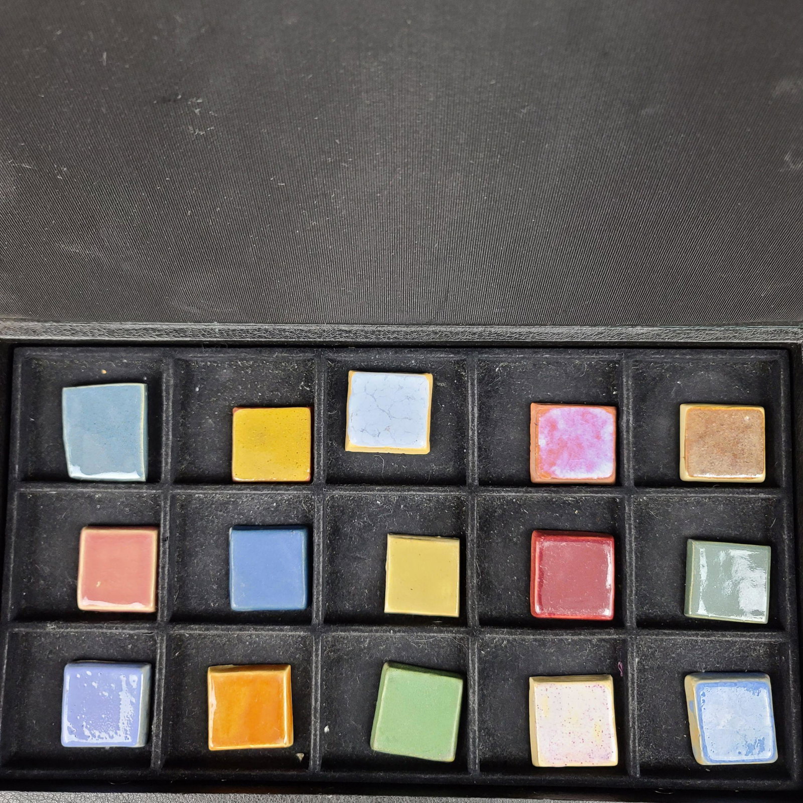 15 North Dakota School Of Mines Pottery Tiles: Lot of 15 University Of North Dakota School Of Mines Pottery Tiles. Measures approx 1.5" square. all mark with glaze info on reverse 1920-50.
