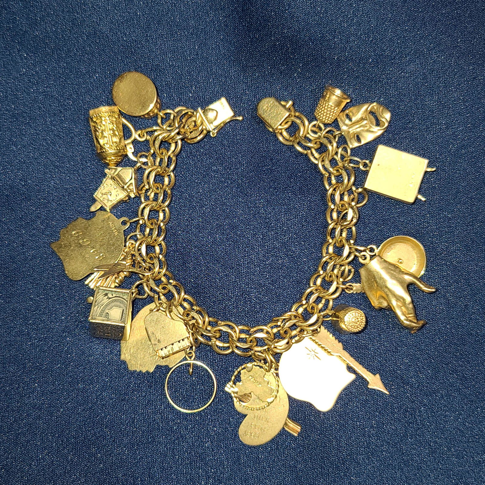 A Fine 14K Gold Charm Bracelet 74 Grams: 14K Gold Charm Bracelet, 74 Grams. Please view photos, there are some really neat CHARMS With MOVABLE PArts.