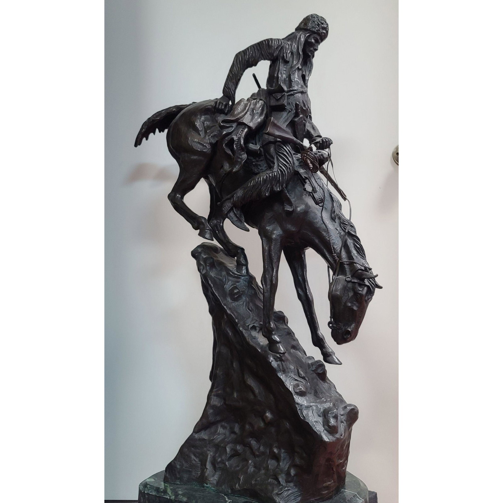 A Large Remington Bronze Sculpture: Restrike Frederic Remington Bronze Sculpture. Measures 39" x 28" Marble base not included.