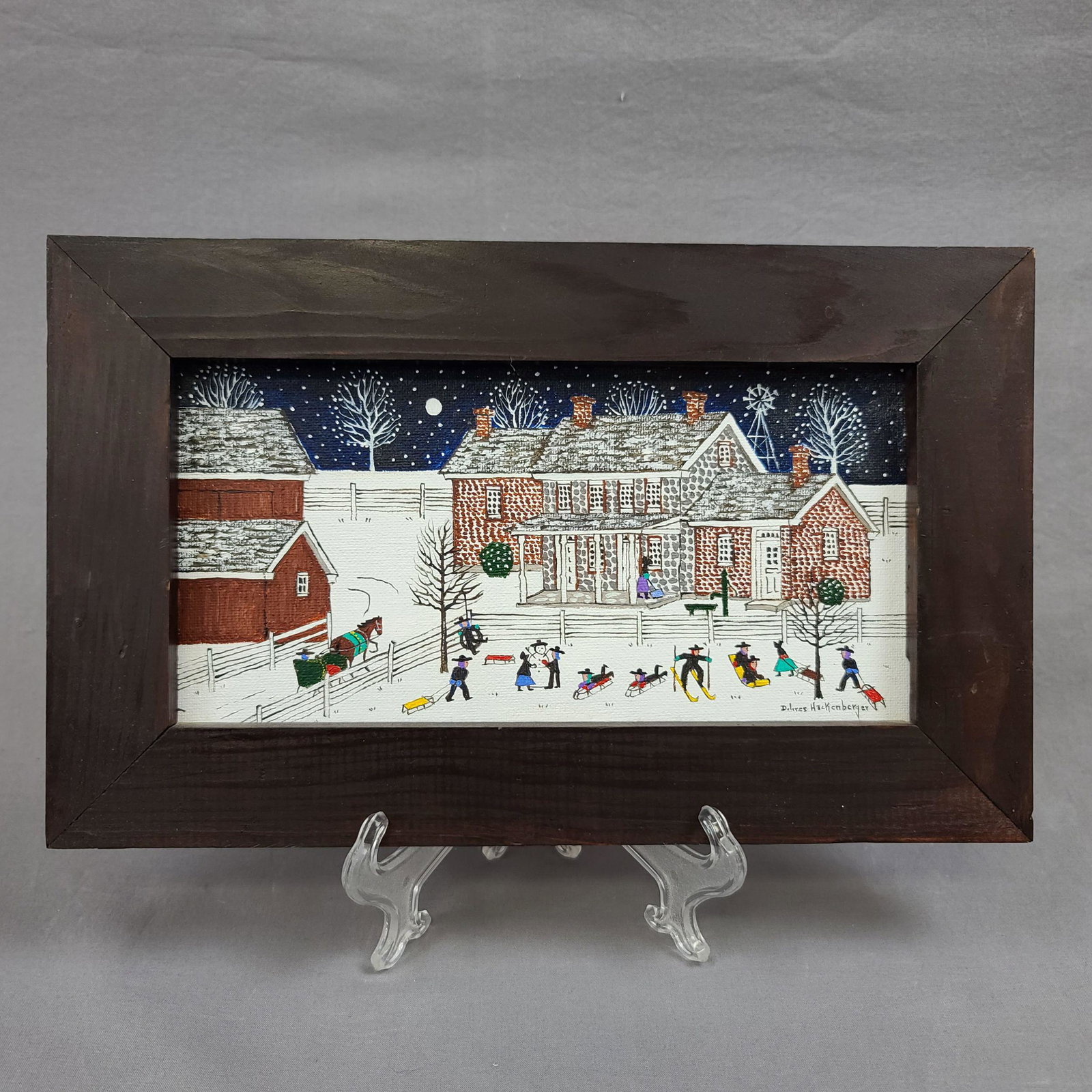 Delores Hackenberger 1930-2020 Folk Art Painting: Delores Hackenberger 1930-2020 Lancaster County PA Folk Art Painting, "Sledding Party Amish". Frame measure 7 3/4" x 12.5", Sight 4 3/4" x 9.5"