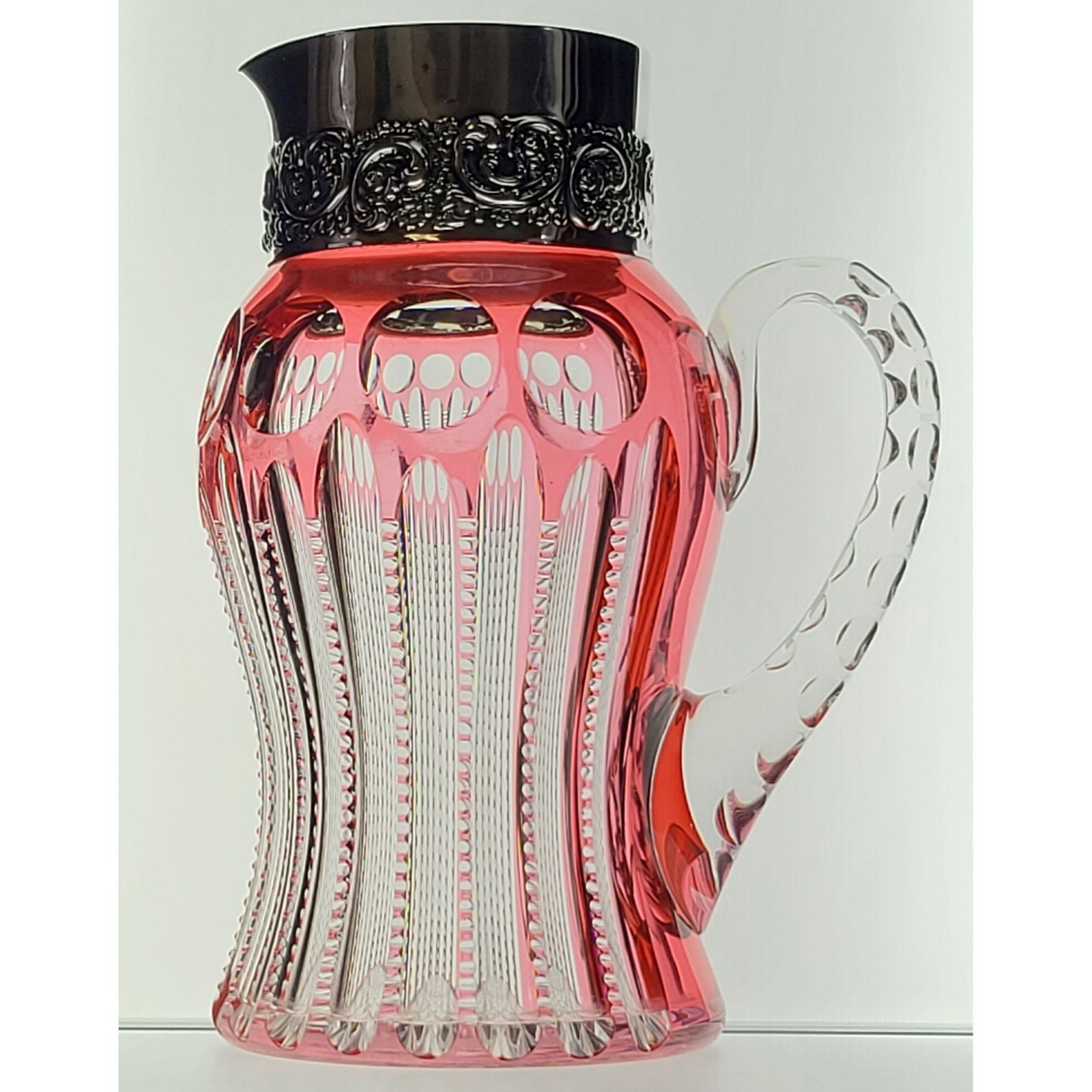 ABP Cut Glass Pitcher, Pairpoint CAMBRIDGE Pattern: ABP Cut Glass Pitcher, Pairpoint CAMBRIDGE Pattern, cranberry cut to clear with sterling silver repousse top. Some denting to silver inside top, outside great shape. Measure 9 1/4" Tall