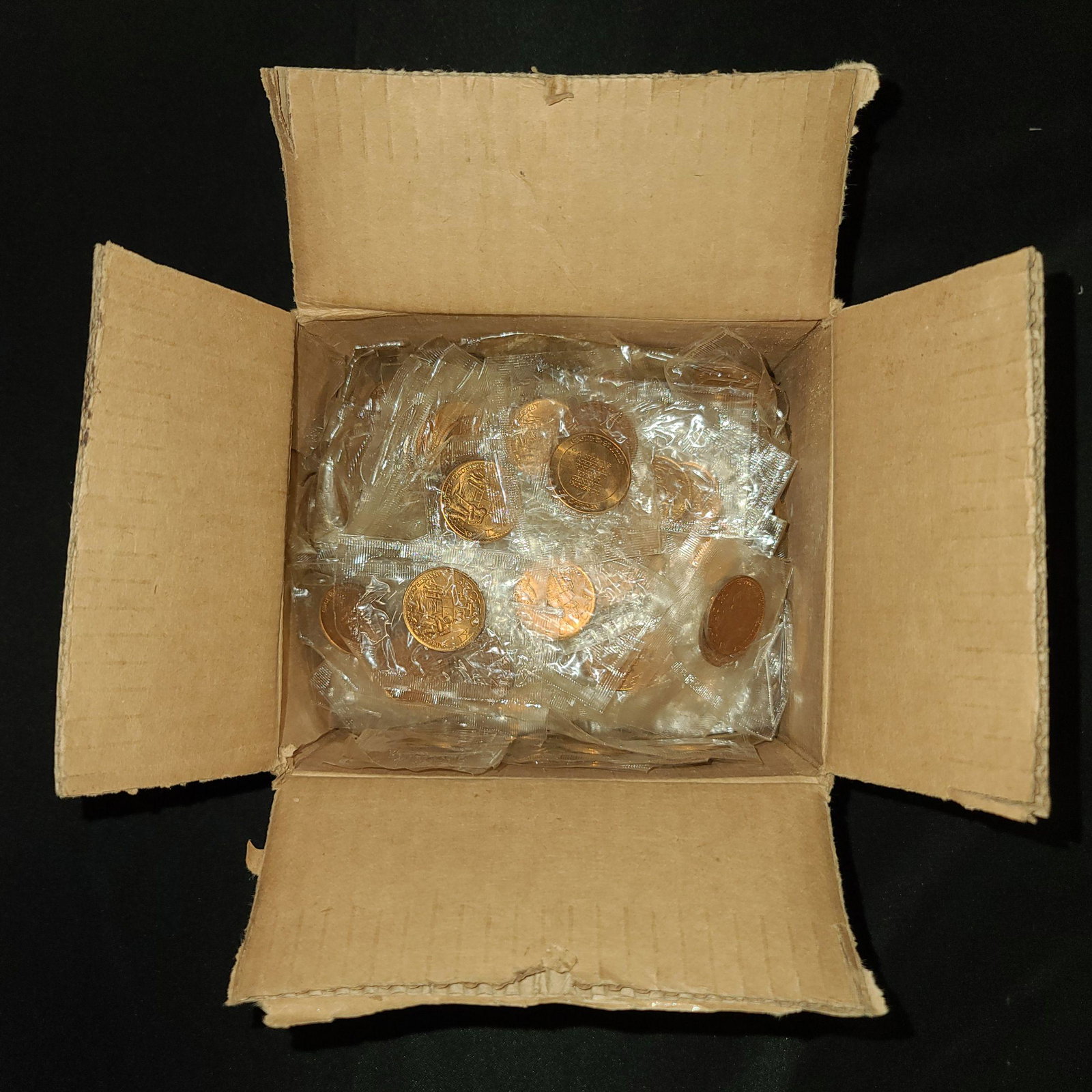 APOLLO 11 XI COMMEMORATIVE COIN TOKEN LOT 300: 300 Apollo 11 commemorative tokens dating from 1969, all new in sealed baggies. Each token measures 1 inch in diameter. Obverse reads "APOLLO XI" across the top, and "ARMSTRONG-ALDRIN-COLLINS" with an