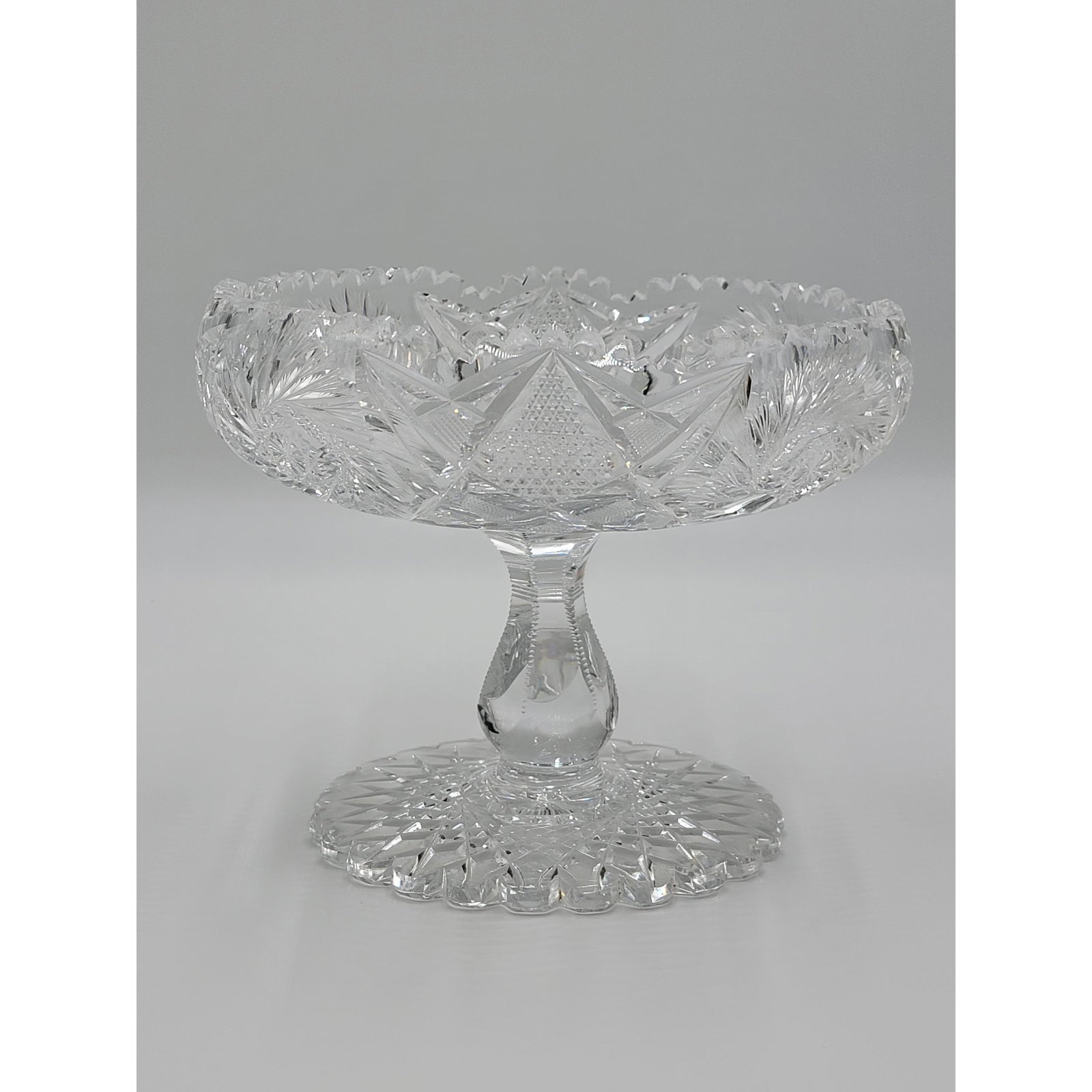 American Brilliant Period Cut Glass CLARK Footed Bowl w: American Brilliant Period Cut Glass CLARK Footed Bowl with Serrated Hob-star Foot, extremely well cut pinwheels and faintly signed in center. Measure 7.5" x 9". There are some tiny fleck on the inner 