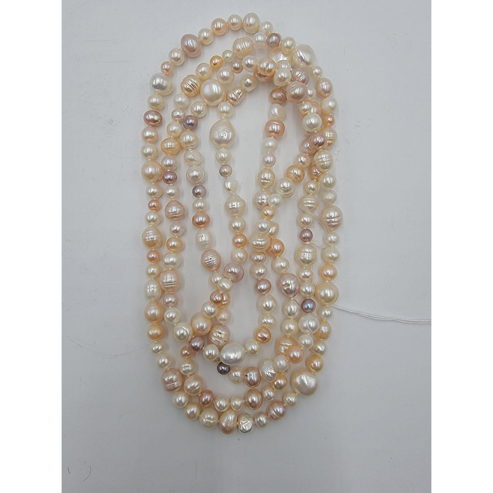 A Very Large String Of Cultured Pearls Natural Rose Col: A Very Large String Of Cultured Pearls Natural Rose Color Baroque Shaped. Measure Approx. 58" Long
