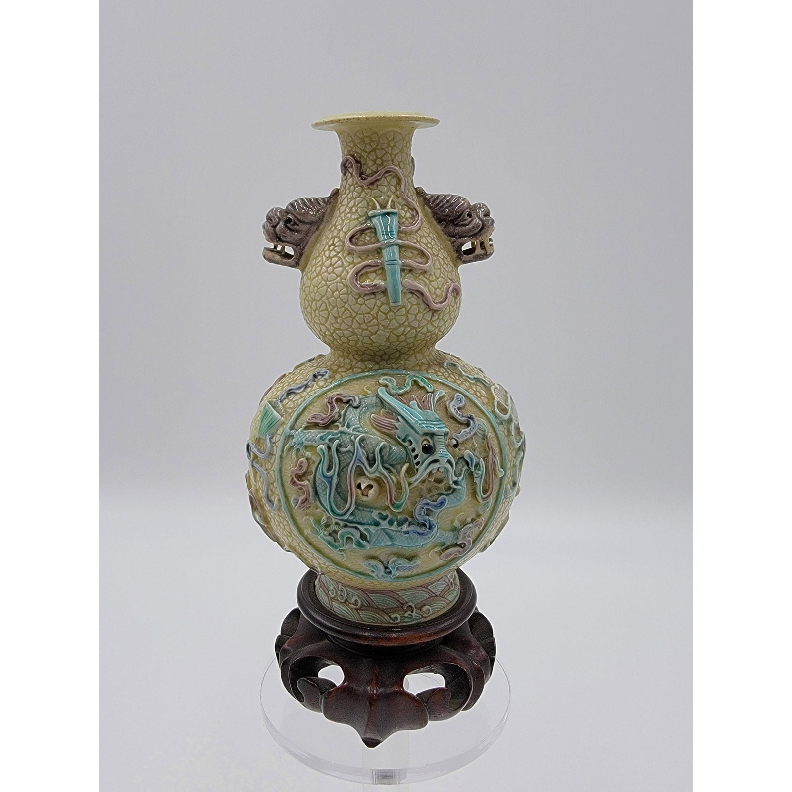 A Nicely Carved Chinese Porcelain Vase W/ Dragons MARK: A Nicely Carved Chinese Porcelain Vase W/ Raised Designs And Dragons With Movable Eyes And Impressed MARK. Measure 5.5" Tall With Wooden Stand Not Being Measured.