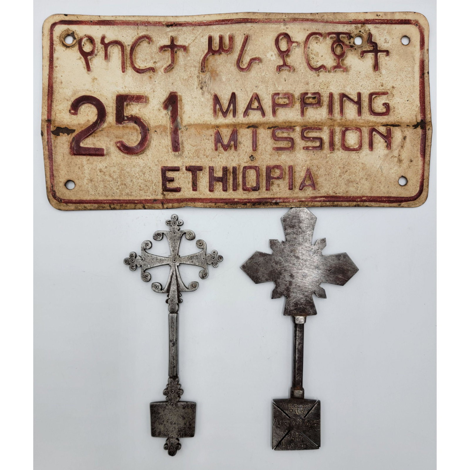 2 Antique Ethiopian Silver Keys & Old License Plate: A collection of three Ethiopian artifacts; consisting of two Nickle silver Keys, and a rare auto license plate originally affixed to the vehicle of a government official. Crosses Measure