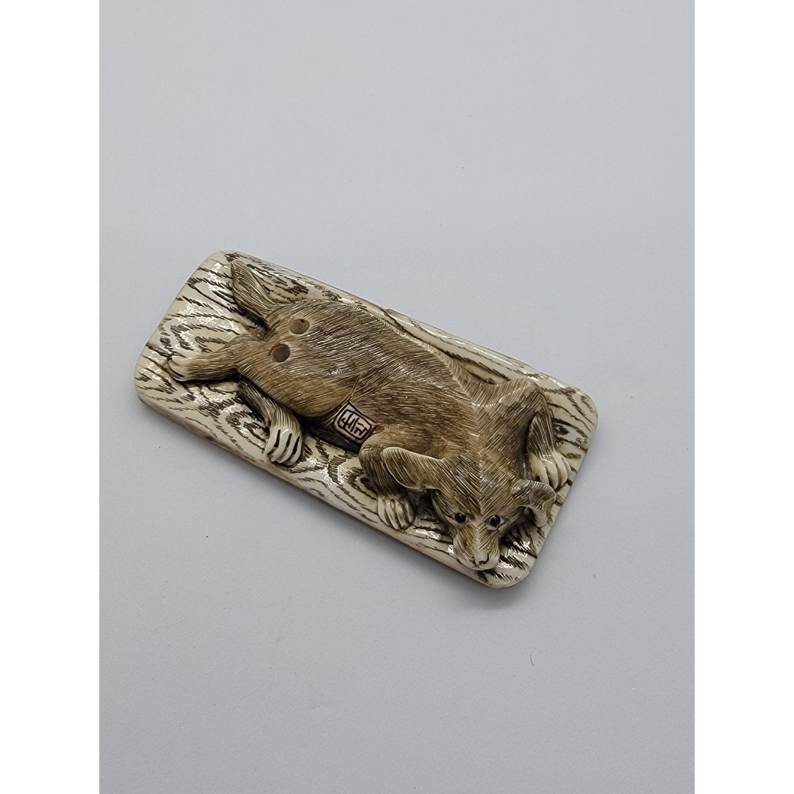 Antique Carved Fossilized Netsuke Of A Dog Signed: Antique Carved Fossilized Netsuke Of A Dog Signed 19 C. Measure 2 3/4" x 1 1/4". Please carefully read our terms of sale, shipping information, and request any condition reports or photos prior to pla