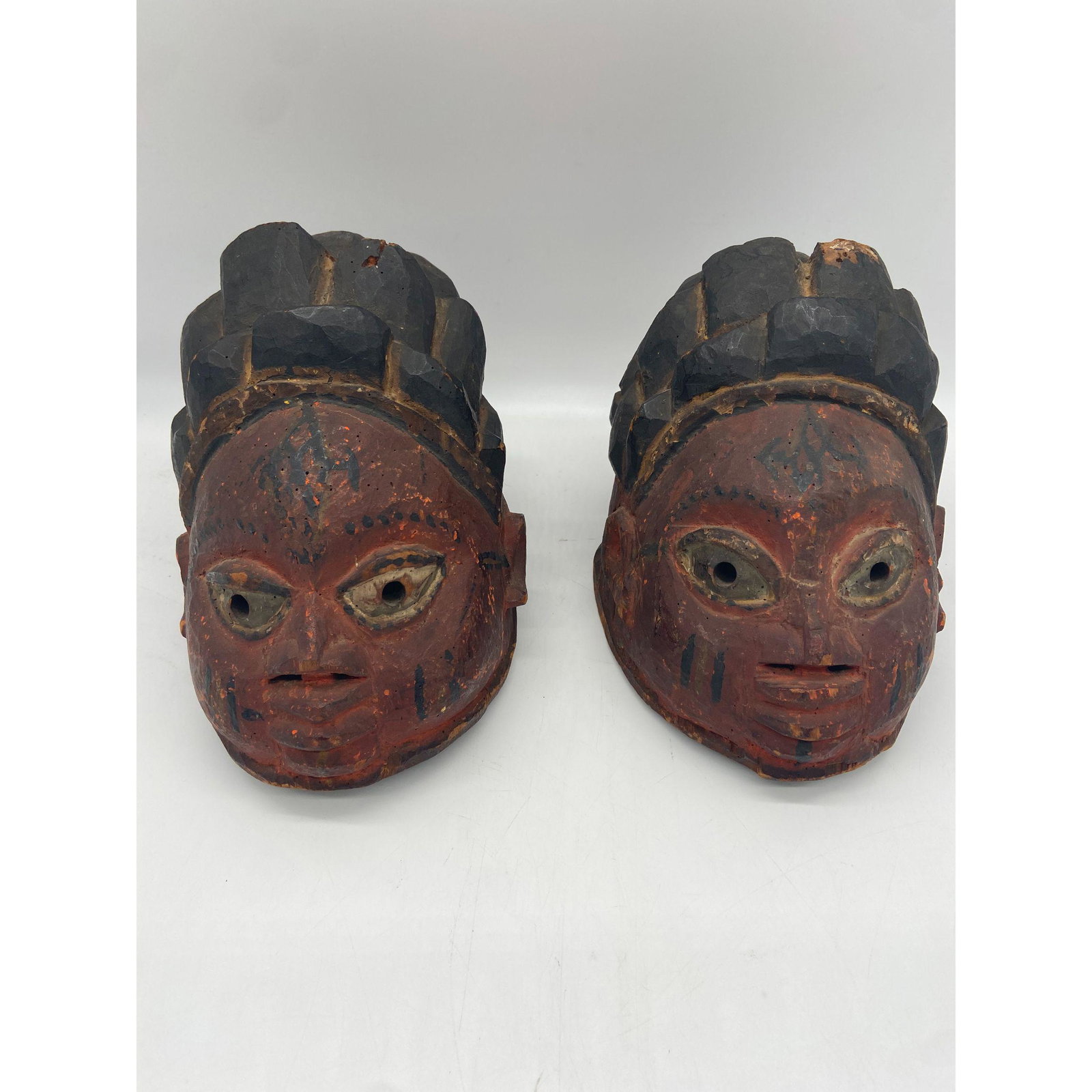 Lot of 2 Yoruba Masks: Lot of 2 Yoruba Masks. Measures 8" High, and 6 1/4" x 8 1/2". Please carefully read our terms of sale, shipping information, and request any condition reports or photos prior to placing a bid. Any con