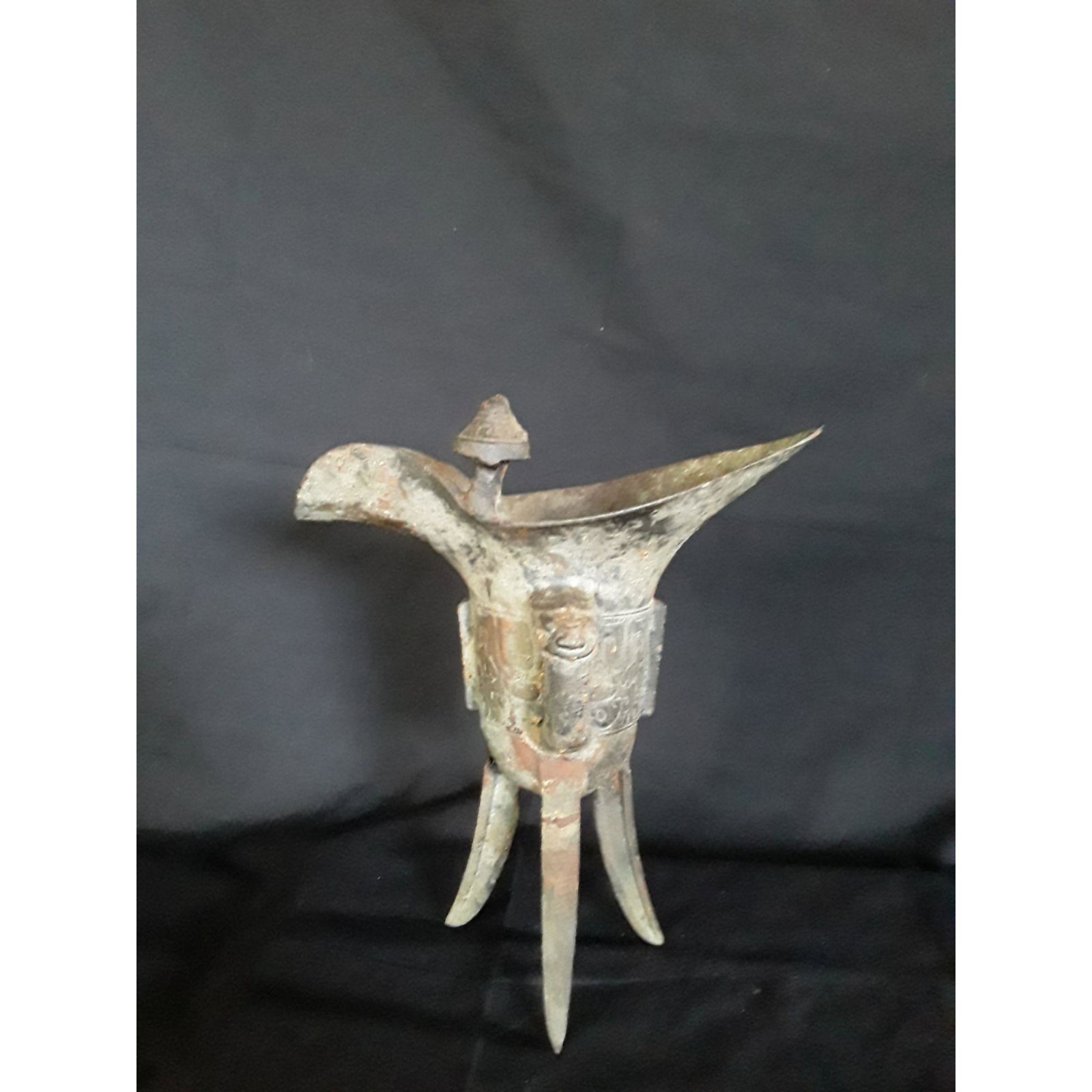 A Chinese Ritual Wine Vessel Bronze Shang Style: A Chinese Ritual Wine Vessel Bronze. Measure 19.5 Cm X 17.5 Cm. Please carefully read our terms of sale, shipping information, and request any condition reports or photos prior to placing a bid. Any c