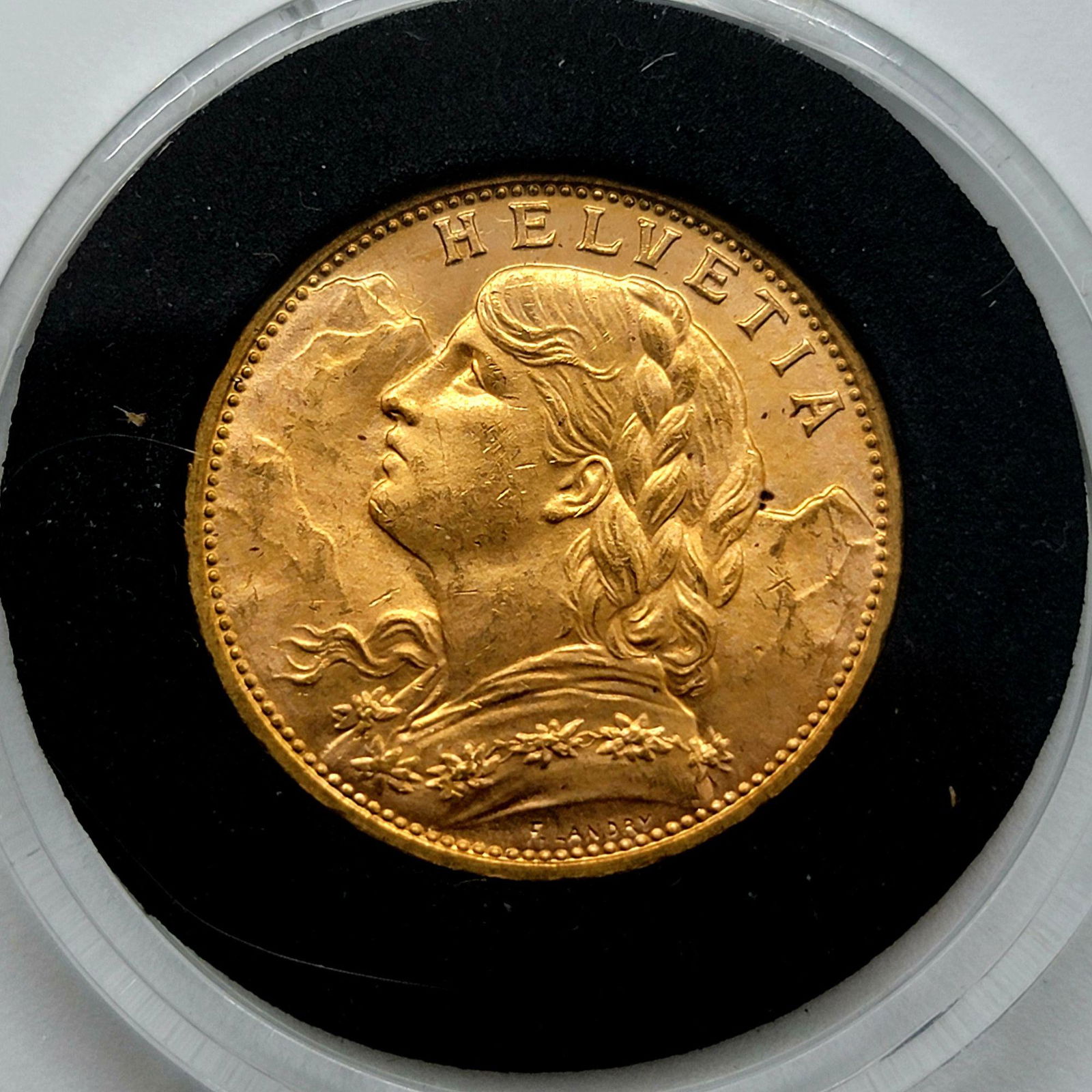 Gold Helvetia Swiss 20 Francs 1914 MS62-63: Gold Helvetia Swiss 20 Francs 1914 MS62-63 Ungraded. Please carefully read our terms of sale, shipping information, and request any condition reports or photos prior to placing a bid. Any condition st