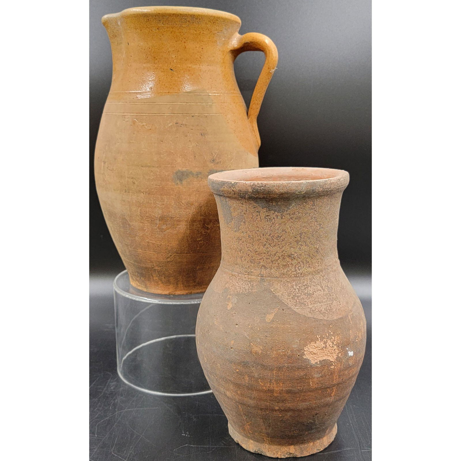 2 Antique Redware Clay Pitcher 19th C: 2 Antique Redware? Clay Pitcher 19th C. Measure 10.5" And 9" Respectively. This item and many more forthcoming are from the estate of a true antiquity connoisseur in every sense of the word. This anti