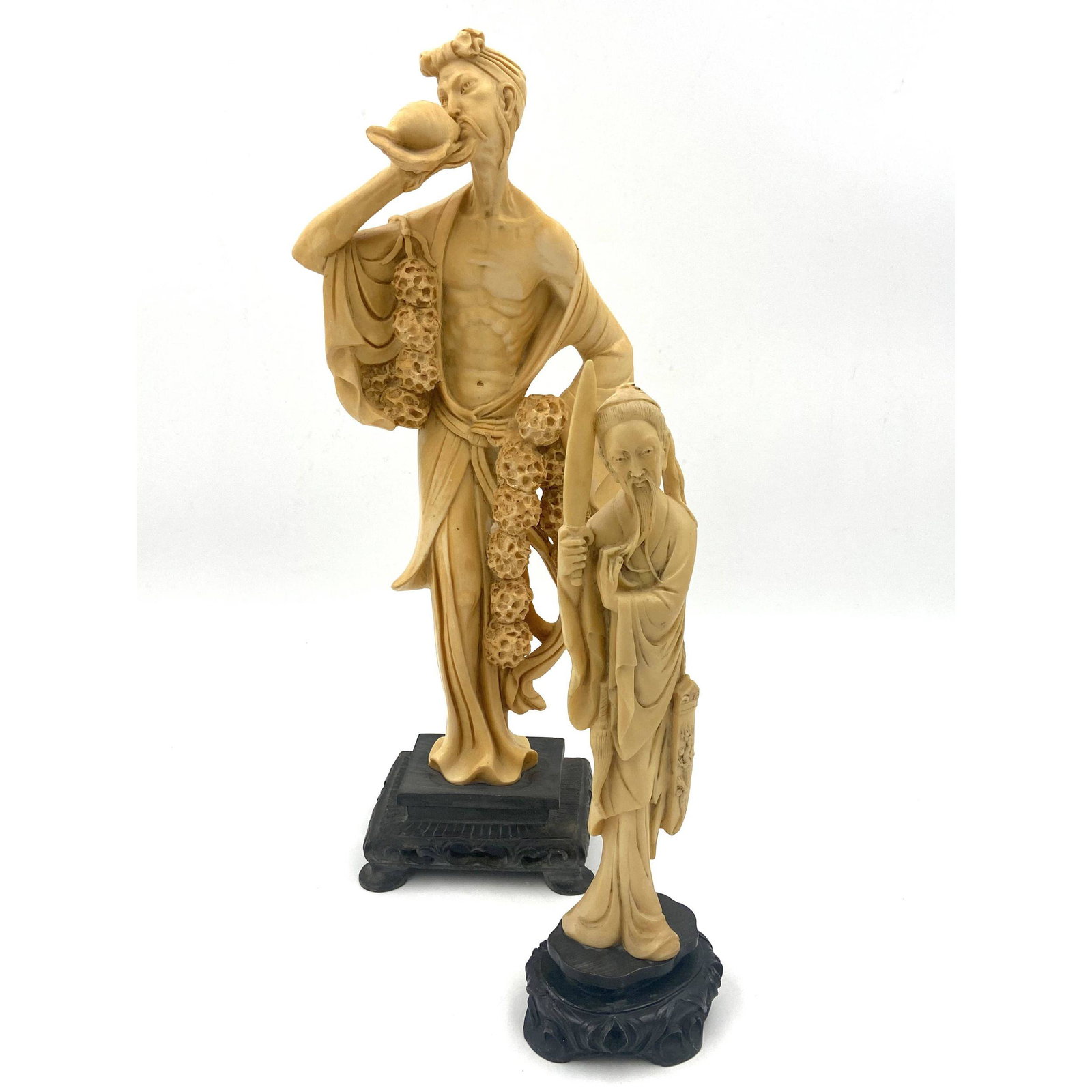Pair Of Chinese Resin Carved Sculptures: Pair Of Chinese Resin Carved Sculptures. Measures 17" and 12" Tall. The Sword On One Has Been Repaired. Comes From A Central Florida Estate... Please carefully read our terms of sale, shipping informa