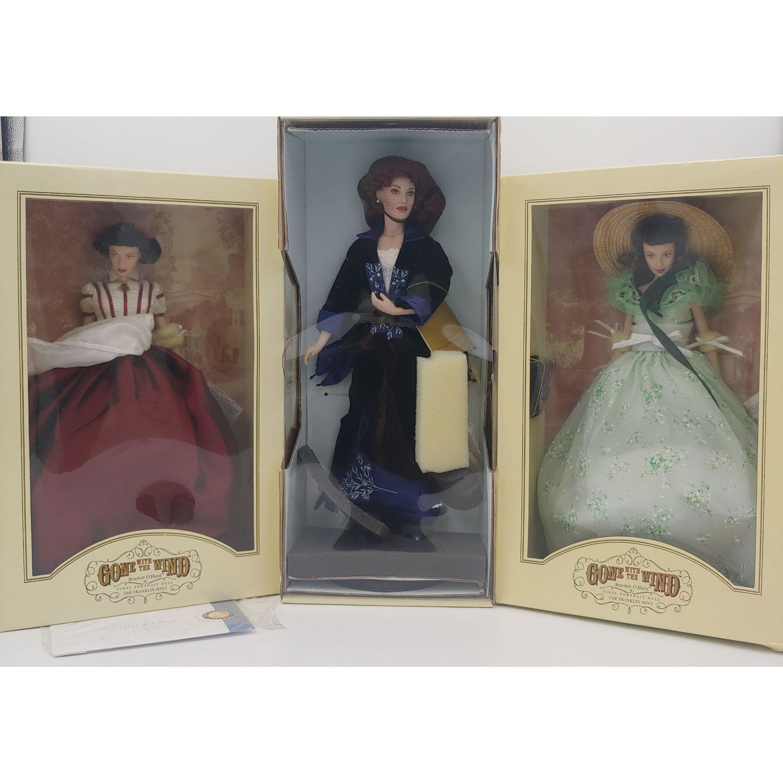 3 Franklin Mint Porcelain Dolls: Rose and a Pair of O'Hara's: 3 Franklin Mint Porcelain Dolls. It consist of Rose from the Titanic on a blue dress, and a pair of Scarlett O'Hara' in different outfits. Please carefully read our terms of sale, shipping information