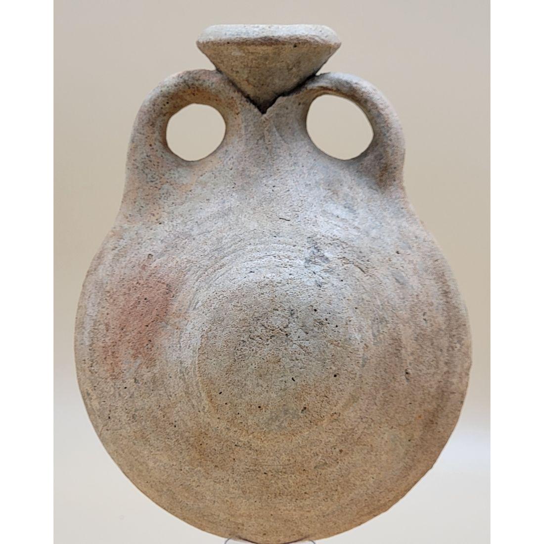 Ancient Egyptian Terra Cotta Pilgrim Flask: Ancient Egyptian Terra Cotta Pilgrim Flask. Measure 6 3/4" X 5.5" X 3". Measure . This, and many lots forthcoming were found at the massive central Florida estate of a true antiquarian who amassed his