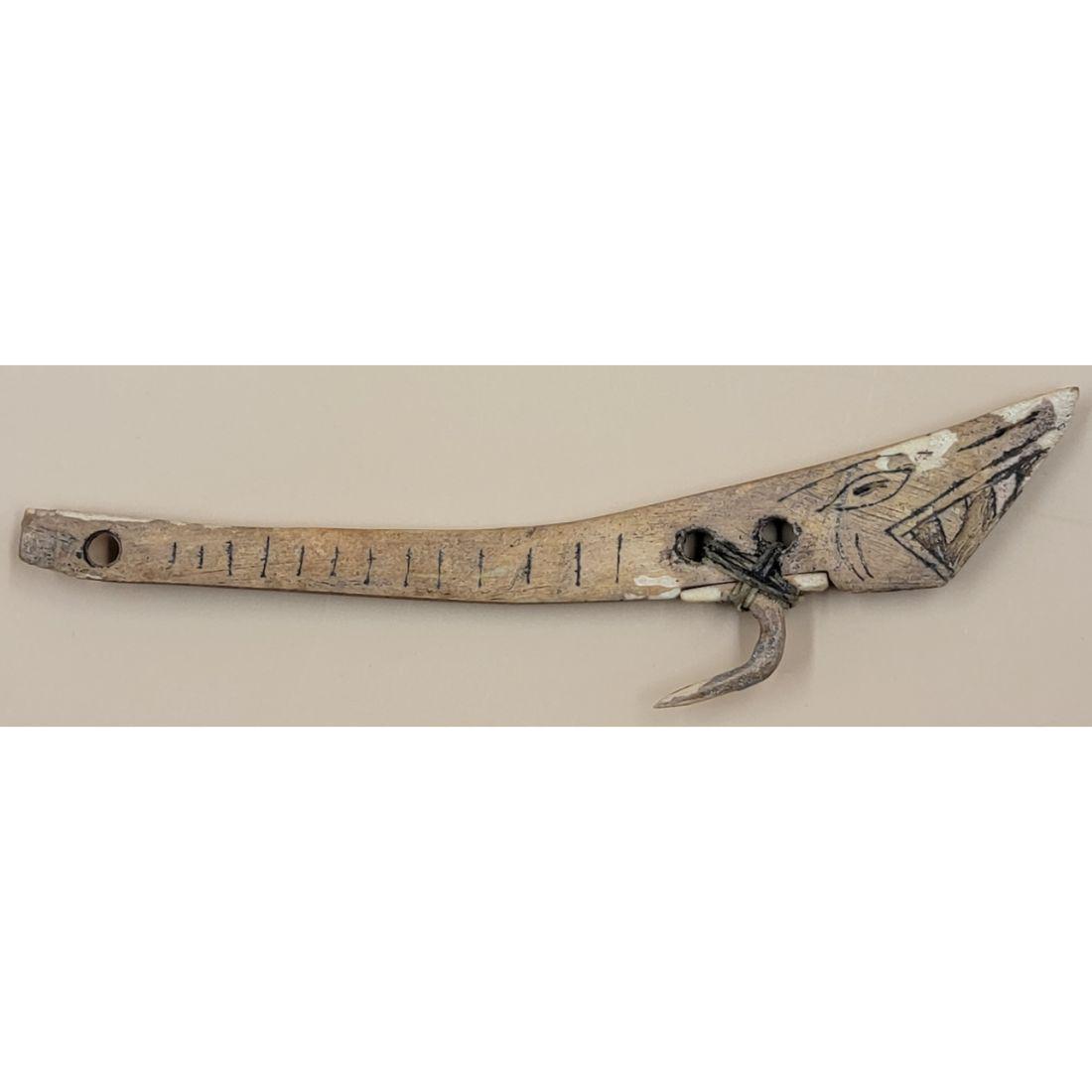 An Inuit Bone Lure / Hook: An Inuit Bone Lure/Hook. Measures 6.5" overall. This, and many lots forthcoming were found at the massive central Florida estate of a true antiquarian who amassed his magnificent collection over a lif