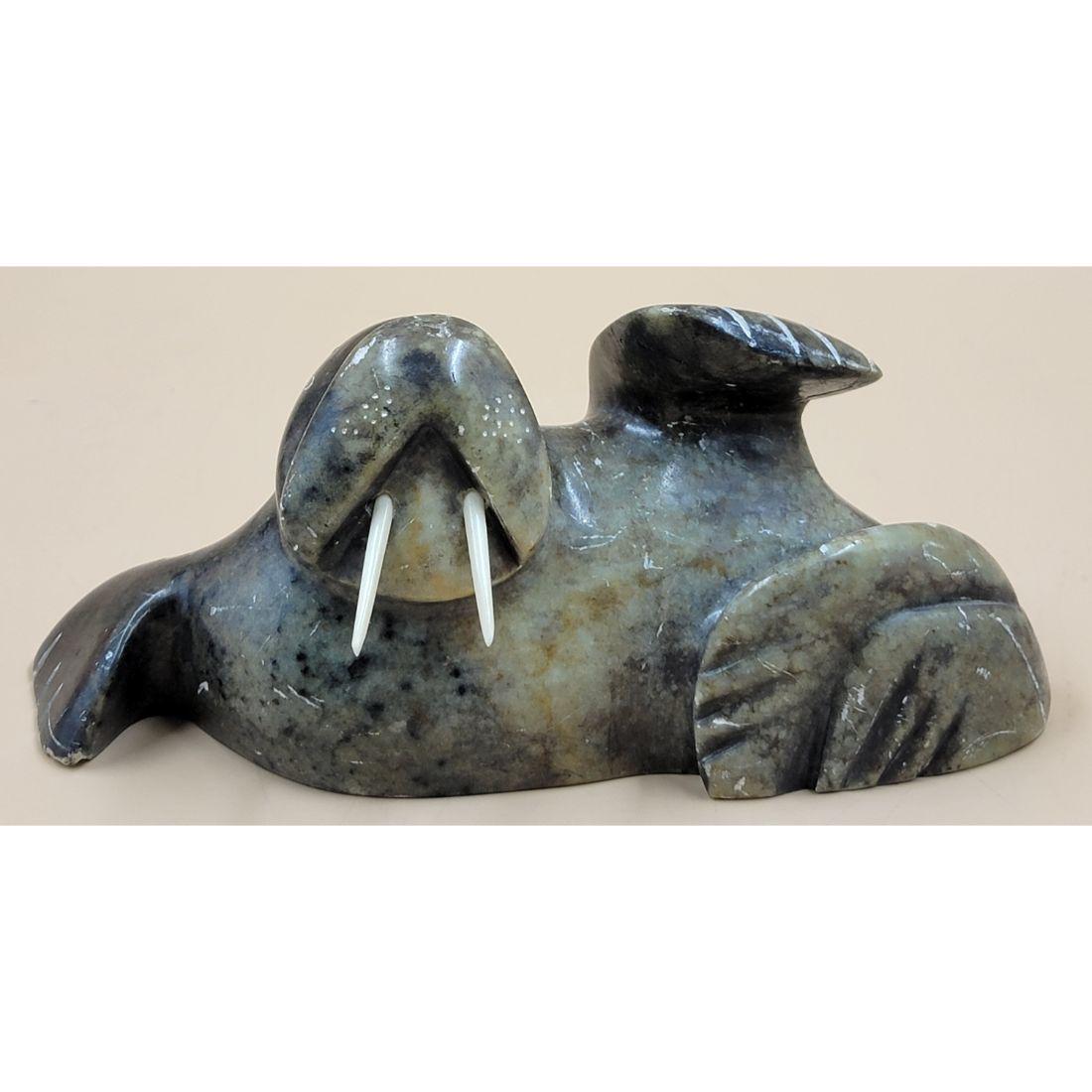 A Signed Inuit Carved Walrus: A Signed Inuit Carved Walrus. Measures 9 1/4" X 3 1/2" X 4". Please read carefully our terms of sale, shipping information, and request any condition reports or photos prior to placing a bid. Any cond
