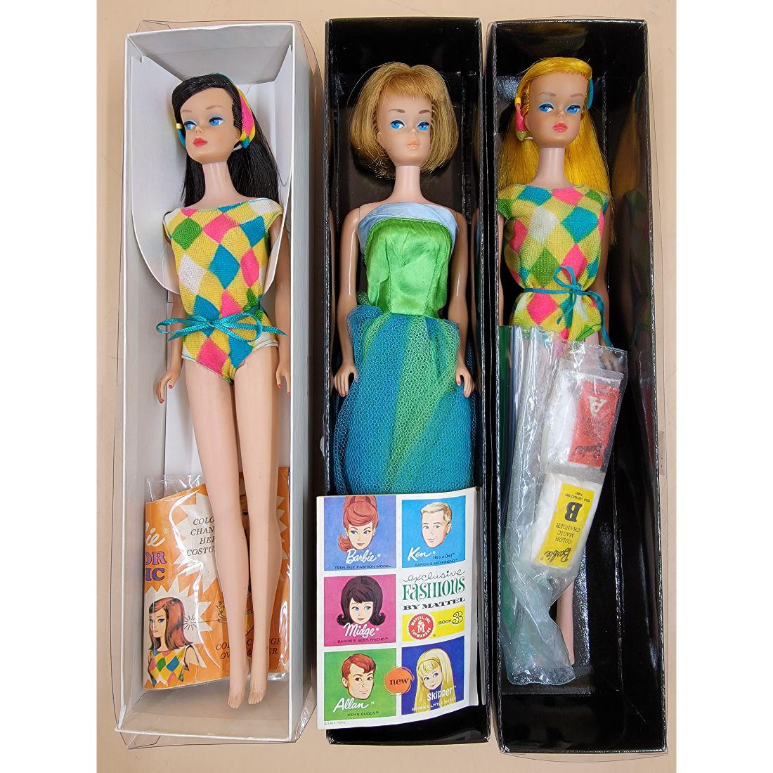 Vintage Barbie Doll: Lot includes 3 Vintage Barbie dolls in original outfits. All come in display boxes. two dolls are believed to be color magic American girls and the other is a standard American girl. All look to be in