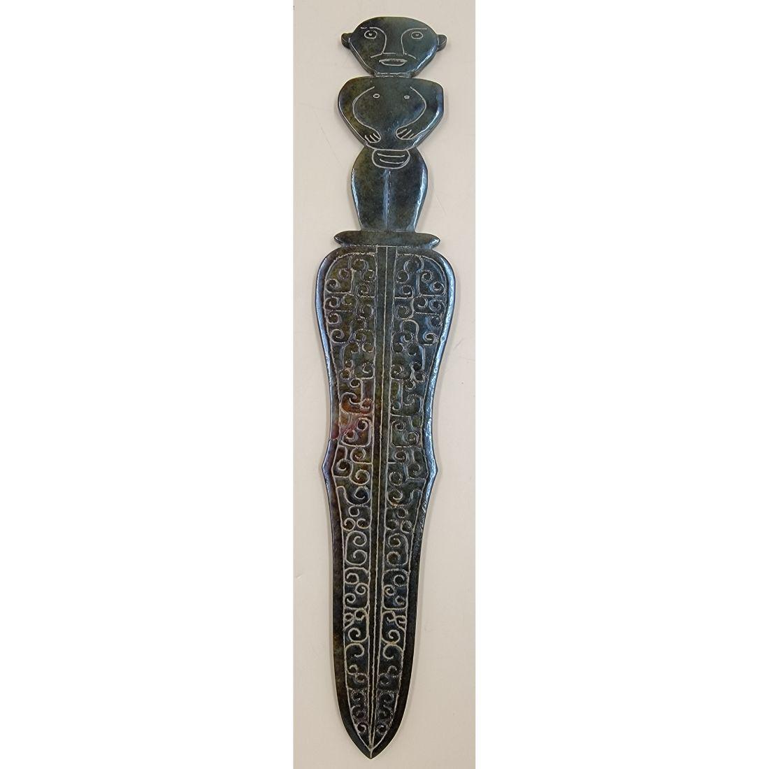 A Carved Chinese Archaic Style Jade Dagger: A Carved Chinese Jade Dagger. Measure 11 3/4" Long. This, and many lots forthcoming were found at the massive central Florida estate of a true antiquarian who amassed his magnificent collection over a