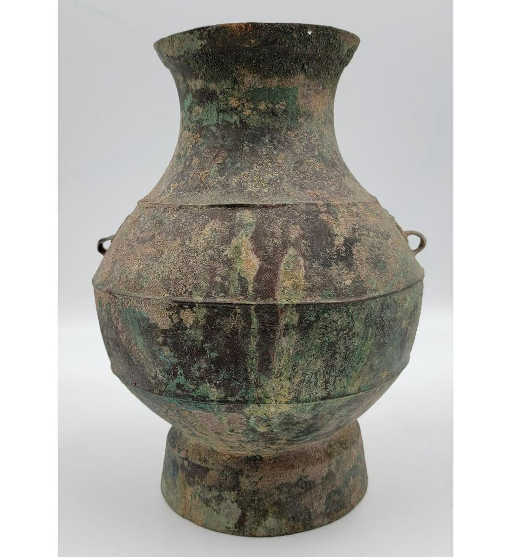 Chinese Han Dynasty Bronze Hu Vase form vessel W/ Taotic Mask Loop: Chinese Han Dynasty Bronze Hu Vase form vessel W/ Taotic Mask Loop. Measures 10.5" x 8". Please carefully read our terms of sale, shipping information, and request any condition reports or photos prio
