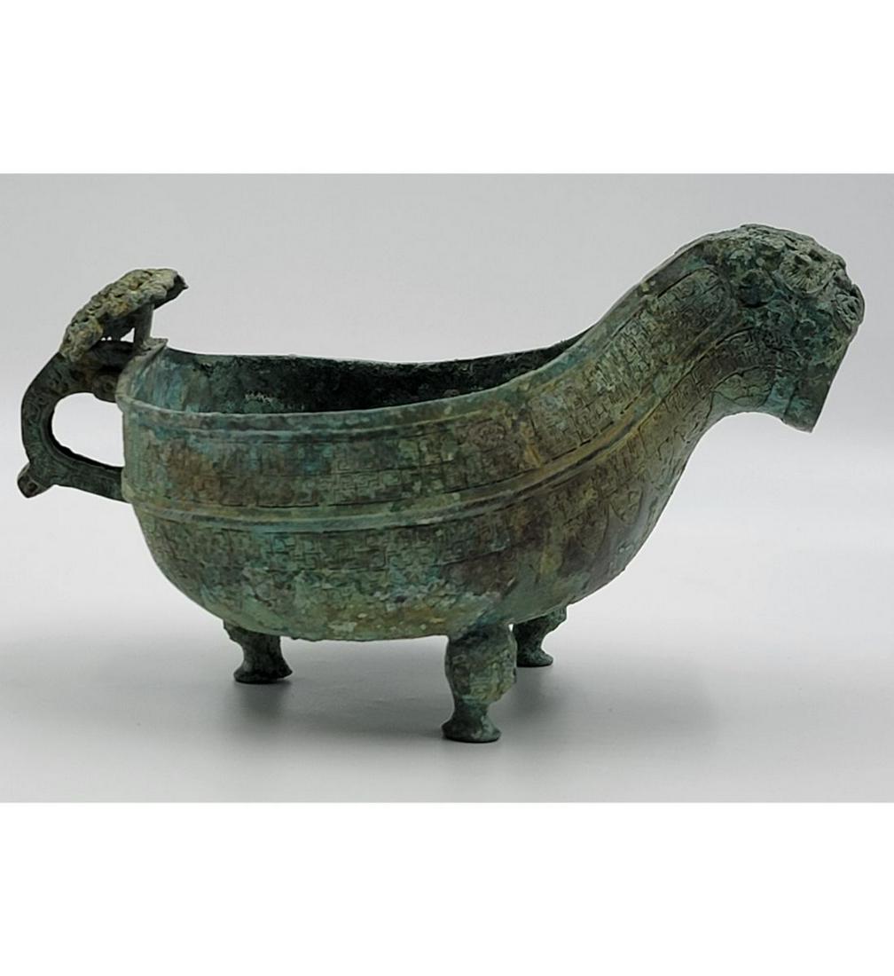 A Chinese Bronze Shang Ritual Vessel: A Chinese Bronze Shang Ritual Vessel. Measures 10" x 5.5" X 7". Please carefully read our terms of sale, shipping information, and request any condition reports or photos prior to placing a bid. Any c