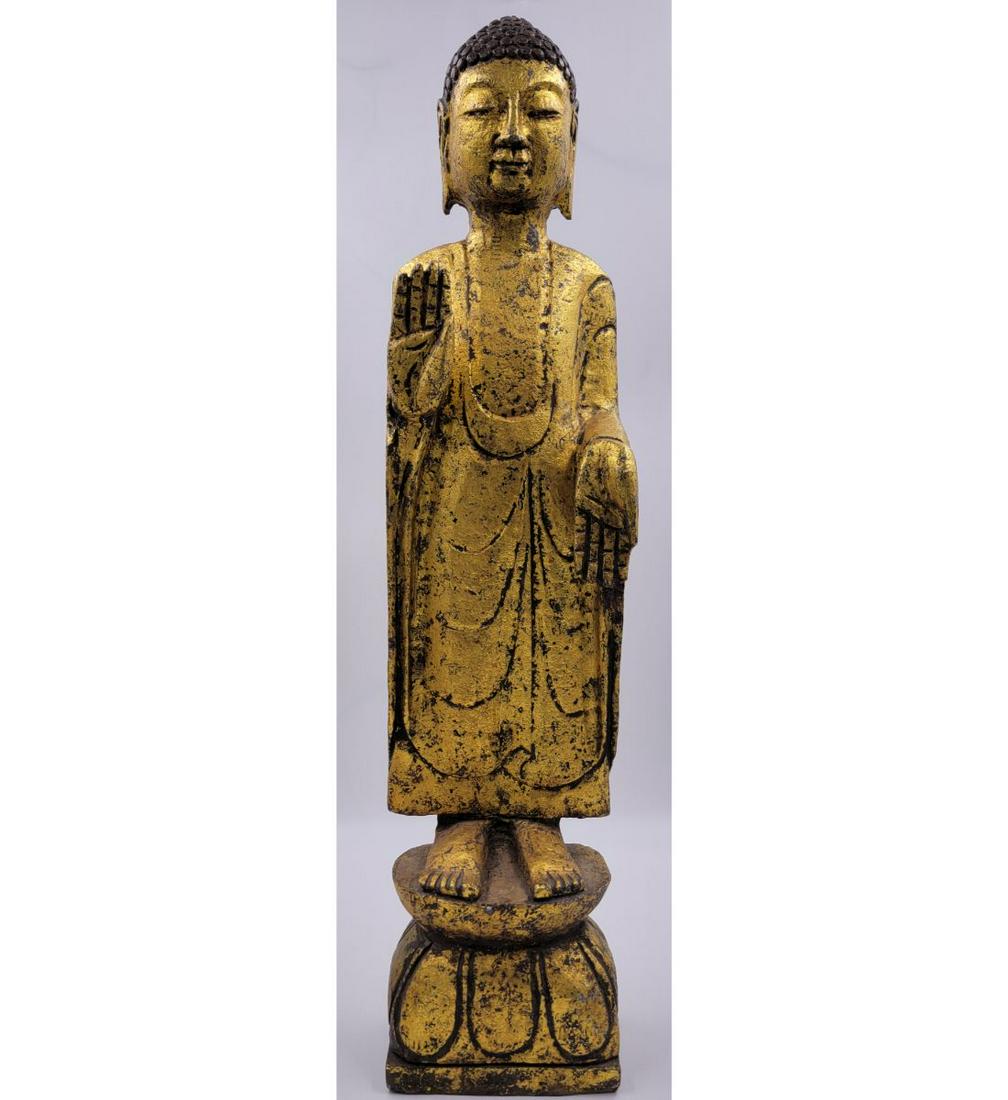 A Chinese Sandstone Standing Gilt Buddha: A Chinese Sandstone Standing Gilt Buddha. Measure 29.5". Please carefully read our terms of sale, shipping information, and request any condition reports or photos prior to placing a bid. Any conditio