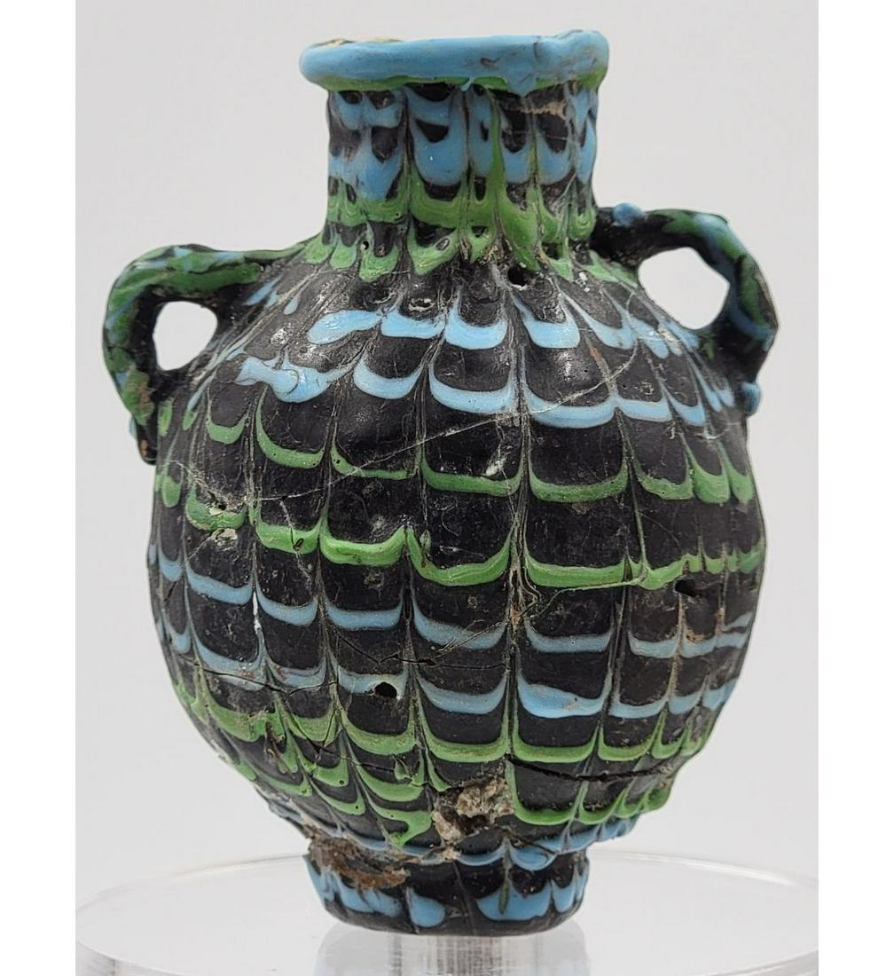 An Ancient Core Glass Vessel Likely Phoenician or Carthaginian: A rare example of a type of early artifact much-coveted by collectors. Former property of a professor of archeology at a well-known American university. Measuring approximately 3.5". READ CAREFULLY! G