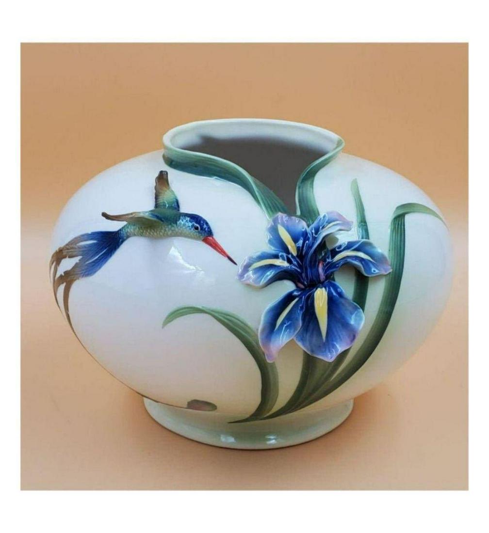 Franz Porcelain Hummingbird & Orchid Vase: Franz Porcelain Hummingbird & Orchid Vase. Measures 7 1/4" tall, with a diameter 10 1/2". Please carefully read our terms of sale, shipping information, and request any condition reports or photos pri