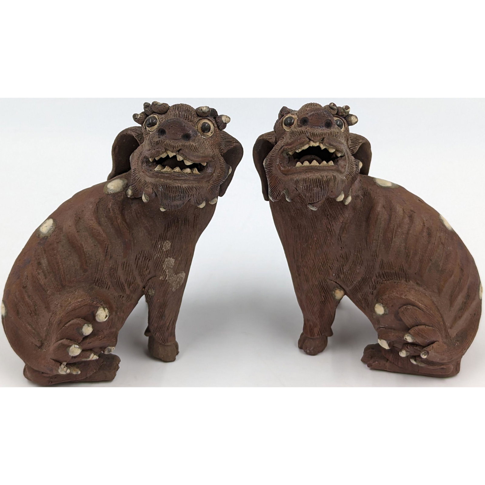 Pair Of Antique Chinese Yixing Clay Foo Dogs: Pair Of Antique Chinese Yixing Clay Foo Dogs. Measures 4" X 4 1/4". Please carefully read our terms of sale, shipping information, and request any condition reports or photos prior to placing a bid. A