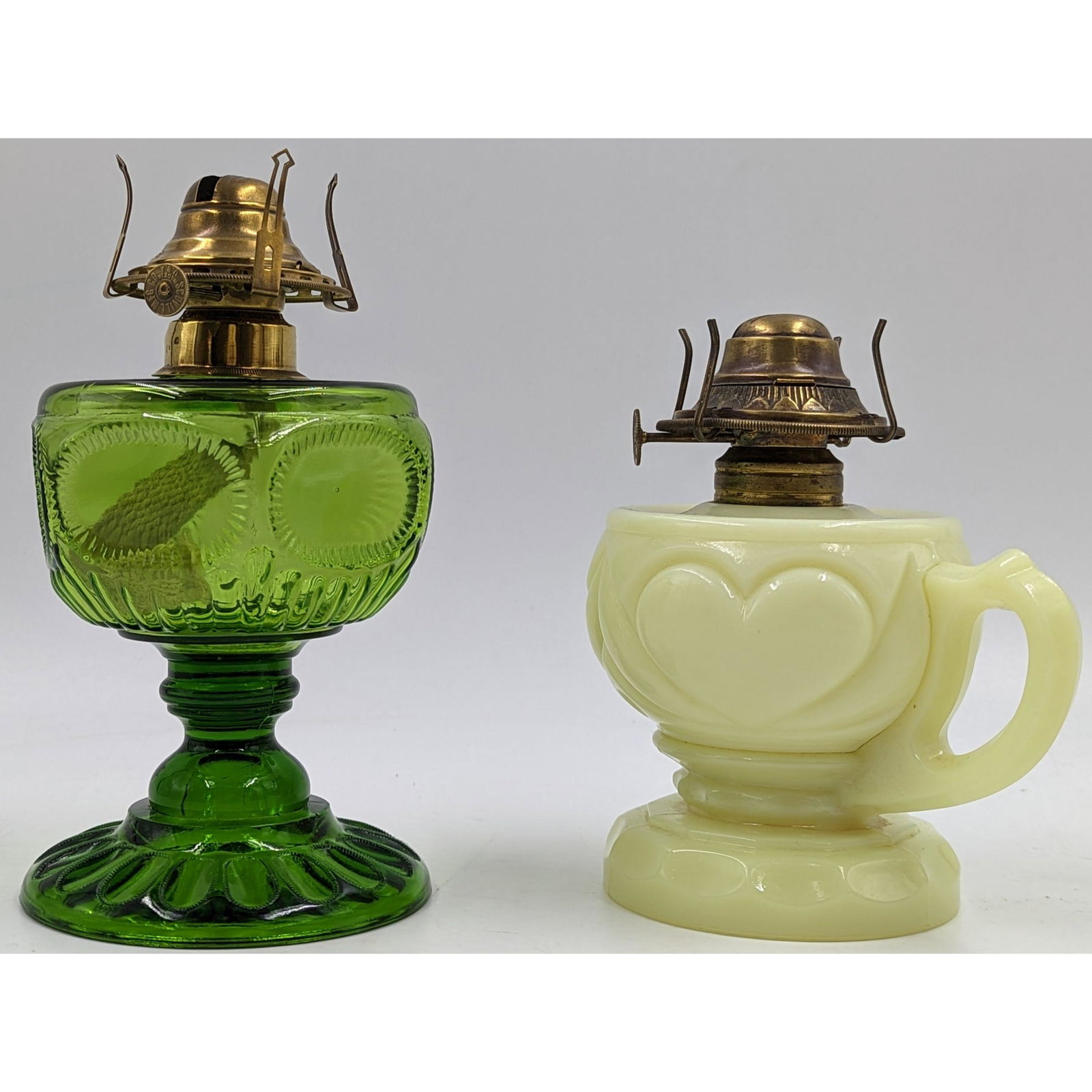 Pair Of 19th Century Miniature Oil Lamps: Pair Of 19th Century Miniature Oil Lamps. Measures approx. 8" and 6 1/2" tall. One lamp has a Dalzell Oval Window design with a patented clich collar. The other lamp appears to be a Custard Heart Vase