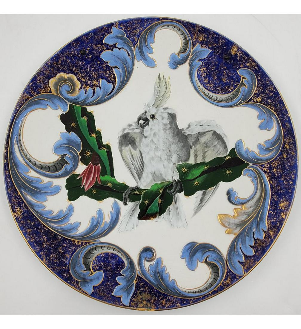 A Handpainted Charger, style of Sergio Bustamante: Large Cockatoo Hanging Charger. It has a Diameter of 20". Please carefully read our terms of sale, shipping information, and request any condition reports or photos prior to placing a bid. Any conditi