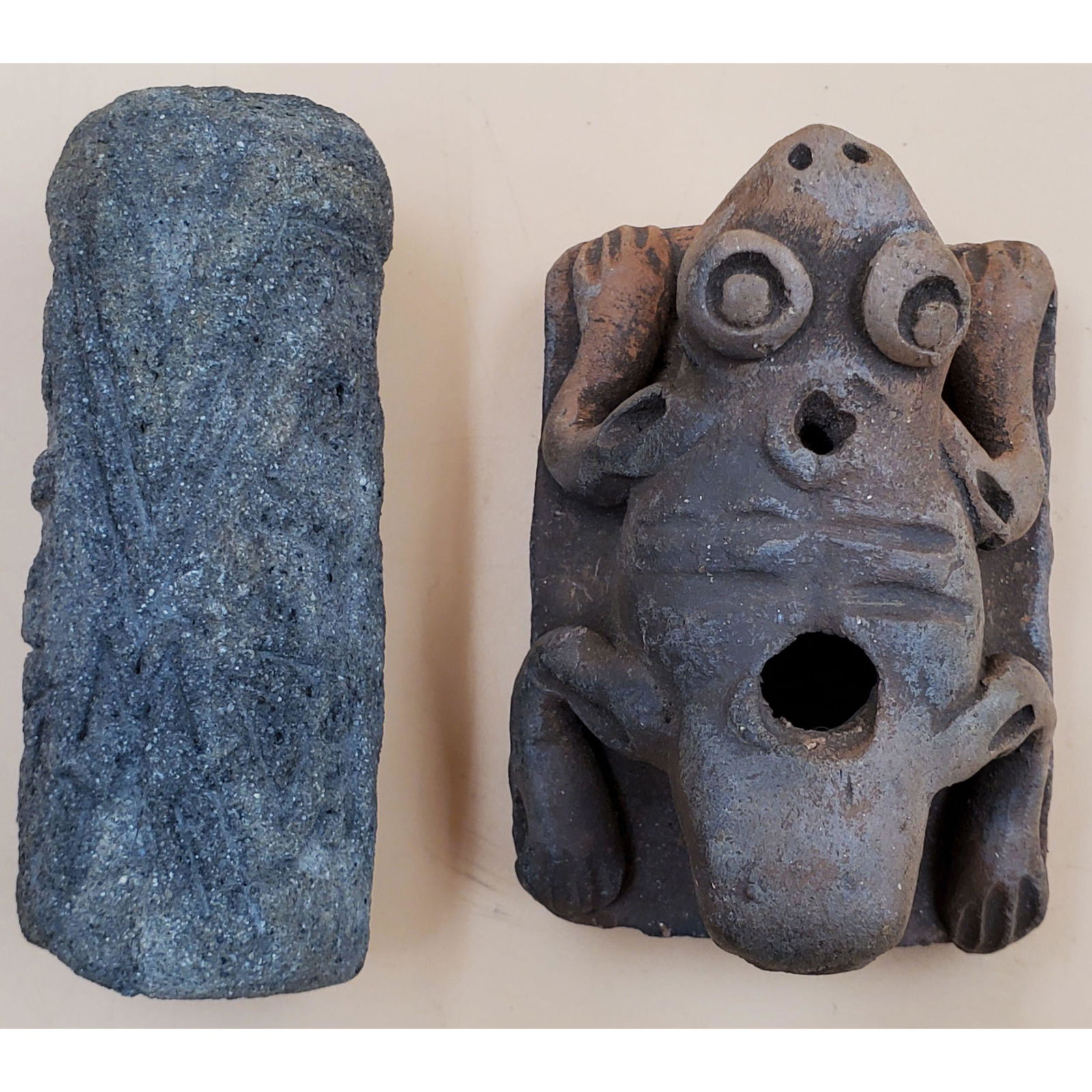 Pre-Columbian Terra Cotta Stamp/Whistle & Implement: Pre-Columbian Terra Cotta Stamp/Whistle & Implement. Stamp/Whistle measures 2 7/8" x 2 1/8" x 1 7/8" and the Implement measures 1 1/4" x 3 1/2". There are some chips on both of these pieces. Please ca