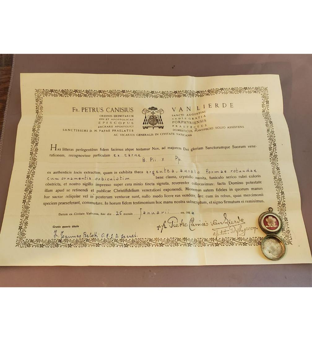 1st Class Relic Of Blessed Pius X With Authentication Document: 1st class relic of Blessed Pius X with authentication document. The relic is ex. carne (skin), and contained in a silver closable locket about 1" in diameter. The document is dated 1954, Rome. A wonde