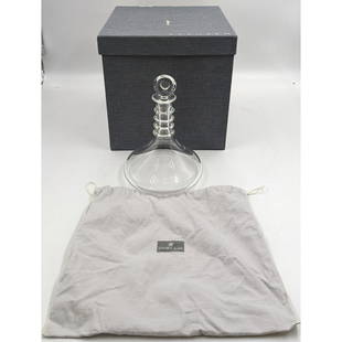 A Fine Steuben Glass Decanter In Original Box And Carrying Bag: A Fine Steuben Glass Decanter In Original Box And Carrying Bag. Measures approx. 10" tall and 7" in diameter. There are a couple of surface scratches, mostly on the bottom, and an etching reading "Ste