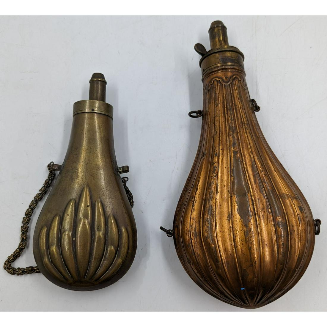 A Pair Of Embellished Civil War Powder Flasks: A Pair Of Embellished Civil War Powder Flasks. Measures approx. 7 1/4" and 10" long. Please carefully read our terms of sale, shipping information, and request any condition reports or photos prior to