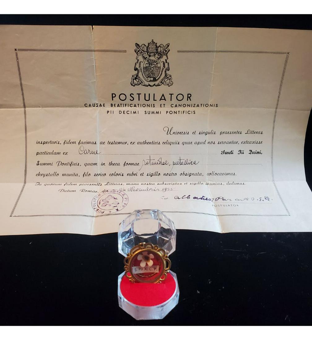 1st class relic of Saint Pius X, Pope, with authentication document: 1st class relic of Saint Pius X, Pope, with authentication document. The relic is ex. carne (skin), and contained in a fancy gold theca. The theca is housed in a Gothic type presentation case. Pope Pi