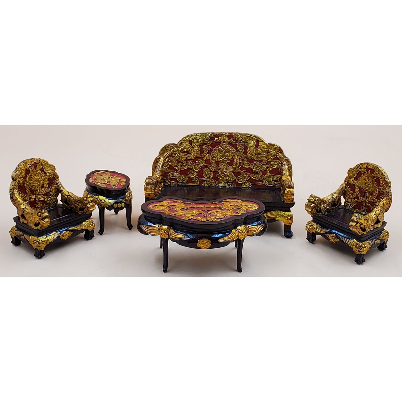 An Ensemble of very rare Chinese Dollhouse Furniture: An Ensemble of very rare Chinese Dollhouse Furniture. Gilded rosewood in excellent condition. Highly unusual, and very fine. The Couch measures 6 1/2" x 2 1/2"x 3 7/8", both the Chairs measures 3" x 2